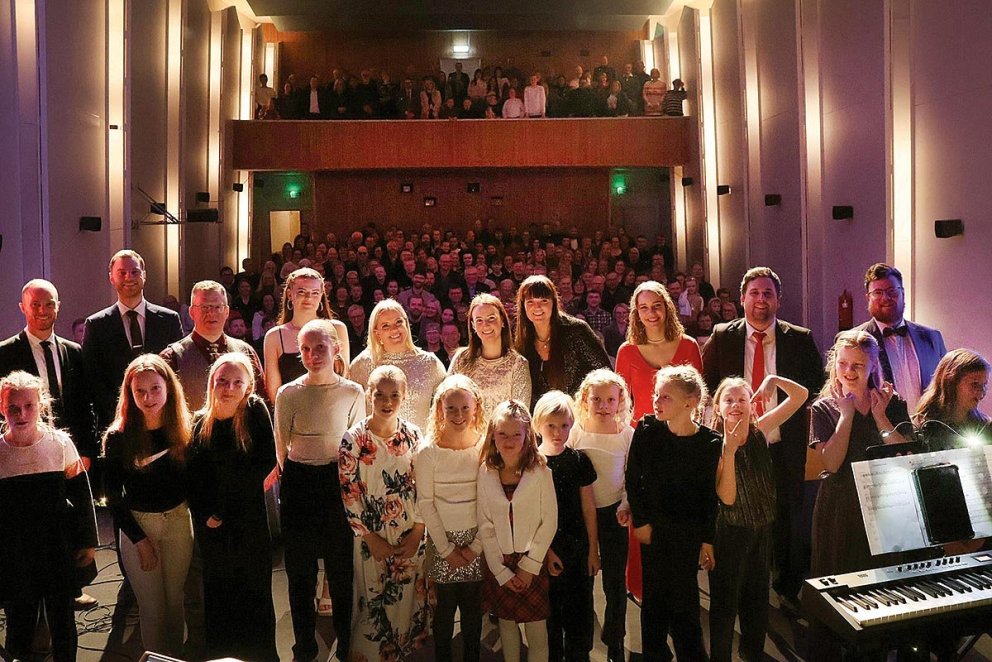 Listafólkið pósar að loknum tónleikum með tónleikagesti í bakgrunni. AÐSEND MYND
