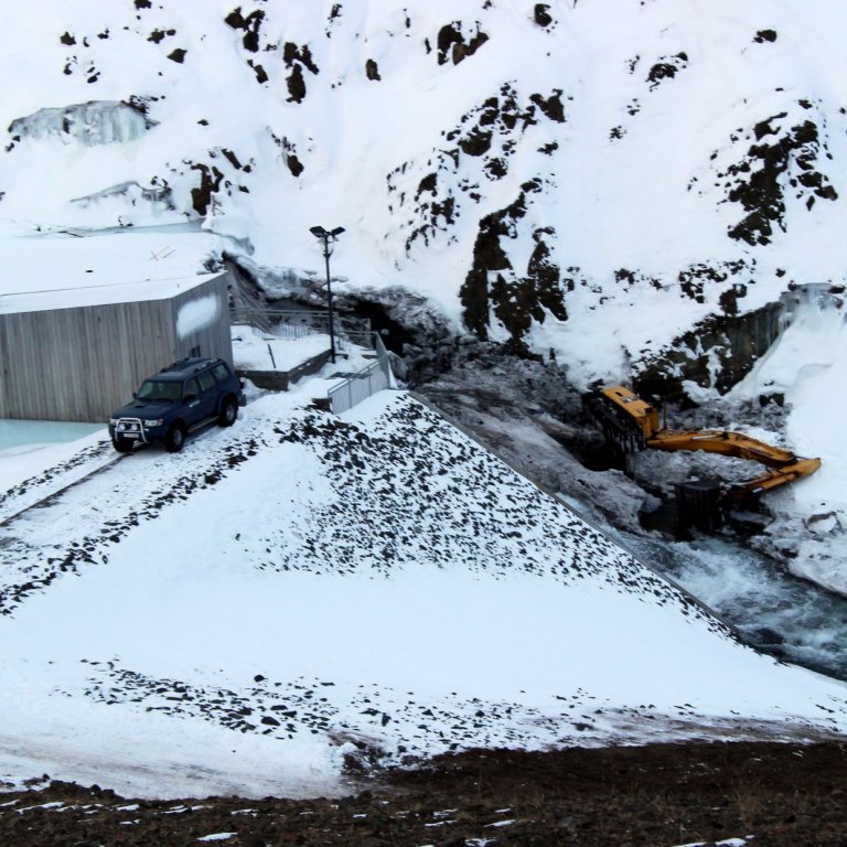 Mikil mildi þykir að engin meiriháttar meiðsli hafi orðið á fólki er stór beltagrafa fór á hliðina í Gönguskarðsá í gær. Mynd: PF.