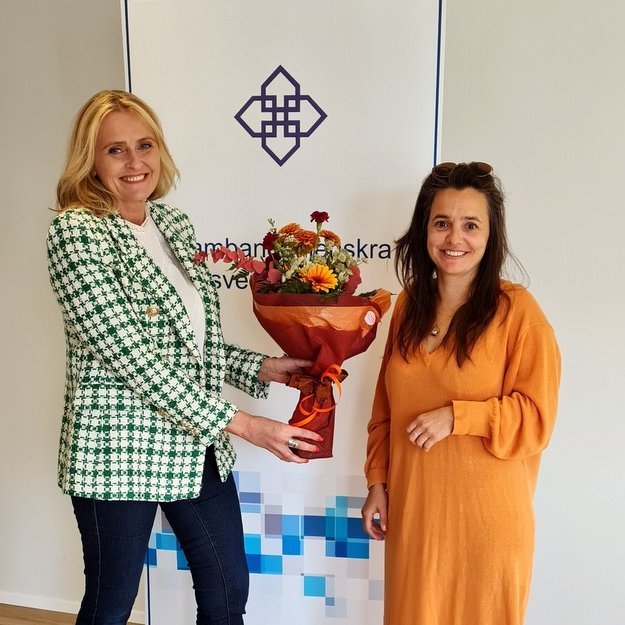 Heiða Björg Hilmisdóttir tekur við blómvendi úr hendi Söndru Líf Ocares sem á sæti í kjörstjórn Sambands íslenskra sveitarfélaga. Aðsend mynd.