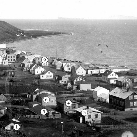Mynd: Sauðárkrókur um 1910. Í þessu umhverfi ólst Eyþór upp og starfaði. Stefánsbær (1), nú Skógargata 18, stendur í brekkurótunum, reistur 1904. Hvammur (2), áður Halldórshús, þar fyrir norðan, nú Skógargata 12. Halldór Þorleifsson járnsmiður byggði það 1898 og bjó þar til 1918 að Þorvaldur Þorvaldsson keypti það og stækkaði til suðurs, verkamaður og ökumaður, verkalýðsleiðtogi um árabil, kvæntur Helgu Jóhannesdóttur og áttu þau sjö börn; meðal þeirra var Rannveig sem lengi söng í kirkjukórnum hjá Eyþóri. Kirkjuhvol (3) byggði Steindór Jóhannesson 1906 en þar bjó lengi Friðrik Hansen kennari með fjölskyldu sinni og byggði hann aðra hæð ofan á húsið; nú Skógargata 15. Sólvang (4) reisti Jónas Sveinsson árið 1904 en Jón Þ. Björnsson keypti húsið 1911 og byggði síðar efri hæðina, nú Skógargata 13. Fjós (5) Jóns Þ. og Friðriks stóð þétt við hús þeirra; síðar reisti Friðrik sitt eigið fjós. Góðtemplarahúsið (6), Gúttó, Skógargata 11, var reist 1897 og stækkað 1903–04 og er það hærri hluti hússins. Barnaskólinn (7) var tekinn í notkun 1908. Fjær blasir við hús Kristjáns borgara (8) eins og Kristján Gíslason var oft kallaður. Hallandi þakið er á Gilsstofu sem ótvírætt var komin á sinn stað 1892 en síðan hvarf hún að hluta til inn í viðbygginguna. Í þessu húsi var verslun K.G. og íbúð. Þar átti Eyþór mörg spor. Ólafur Briem snikkari reisti það hús sem stóð við Aðalgötu 22 (9) árið 1886 og bjó þar þangað til K.G. keypti það litlu fyrr en heimsstyrjöldin hófst 1914 og opnaði þar vefnaðarvöruverslun sem jafnan var kölluð Bræðrabúð, kennd við syni kaupmannsins. Sissa var þar oft við afgreiðslu. Breski herinn tók þetta hús til sinna þarfa árið 1940 og brann það til kaldra kola 4. september um haustið. (Heimildir: Saga Sauðárkróks, Skagfirskar æviskrár, Hannes Pétursson.) HSK.