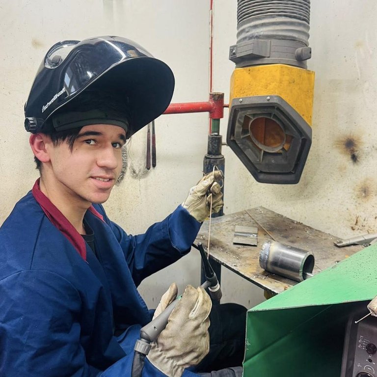 David Glisovic situr í suðuklefanum. Hann er bæði í vélstjórn og vélvirkjun og á þriðja ári í námi.  MYND af Facebook-síðu Lilju D. Alfreðsdóttur